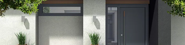 A modern, solid dark grey entrance door with a long vertical handle, set into a contemporary house exterior with wood slat details