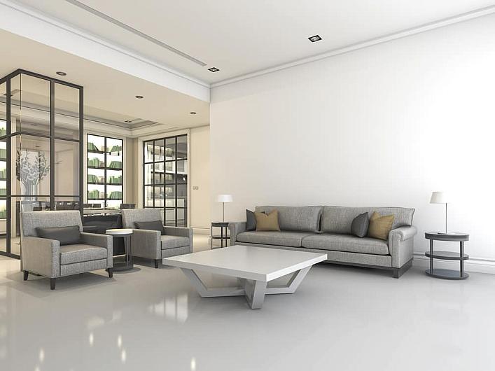A modern living room with grey sofas. In the background, a black steel-replacement screen divides the space from a library
