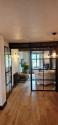 Black steel-look internal doors with one door open flat against the wall and the other door closed
