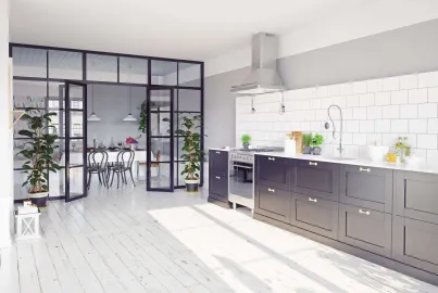 Modern kitchen viewing a dining room through an open black Aluco steel-look screen and double doors