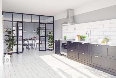 Modern kitchen viewing a dining room through an open black Aluco steel-look screen and double doors