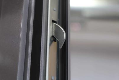 Macro shot of the high-security metal locking hook mechanism on an Origin door frame