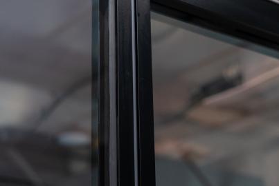 Close-up of the slimline patio door panels neatly stacked to the side when open, showing the floor track