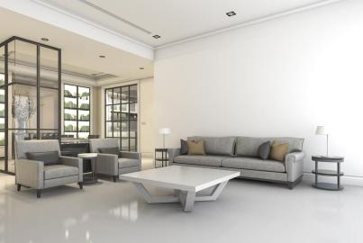 A modern living room with grey sofas. In the background, a black steel-replacement screen divides the space from a library