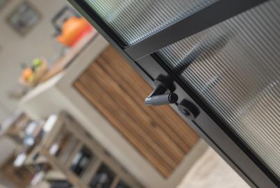 Close-up of a black lever handle on an Origin OI-30 internal door, showing the detail of the reeded glass