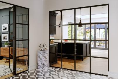 Modern room with black and white tile, featuring a black Origin OI-30 screen and a matching open bifold door