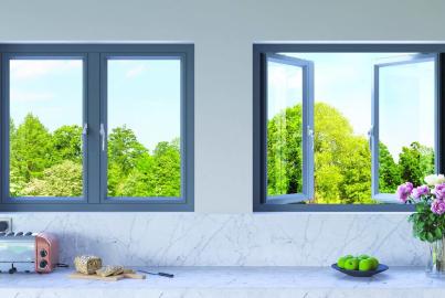 Two grey Origin windows above a marble countertop. One window is closed, and the other is a casement window shown fully open
