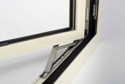 Close-up of the metal friction hinge and black seals on an open, cream-coloured Alitherm casement window