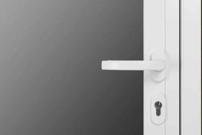 Close-up of a modern white lever handle and keyhole on an Origin double door with frosted glass