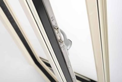 Detailed close-up of the stainless steel locking mechanism and hinges on an open Origin window