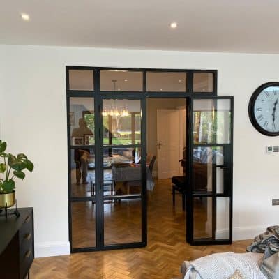 steel look aluminium doors separating a living and kitchen in a house