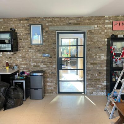 steel look aluminium doors showing modern room with internal black metal door