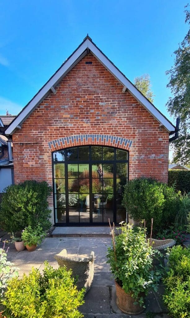 steel look doors in wiltshire house to a table brick extension