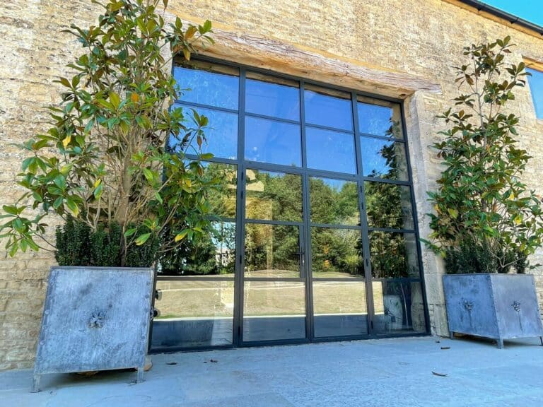 steel replacement French doors with surrounding plant pots